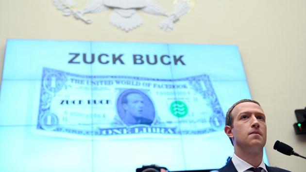 Facebook Chairman and CEO Mark Zuckerberg testifies in front of a projection of a 