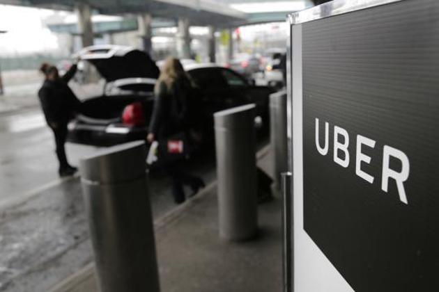 FILE - In this March 15, 2017, file photo, a sign marks a pick up point for the Uber car service at LaGuardia Airport in New York. Ride-hailing giant Uber has filed confidential preliminary paperwork for selling stock to the public. That's according to a report late Friday, Dec. 7, 2018 in the Wall Street Journal. (AP Photo/Seth Wenig, File)