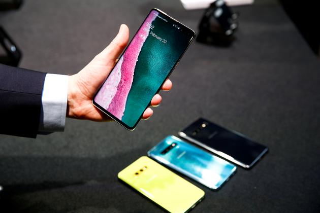 A journalist holds Samsung Galaxy S10 smartphone at a press event.