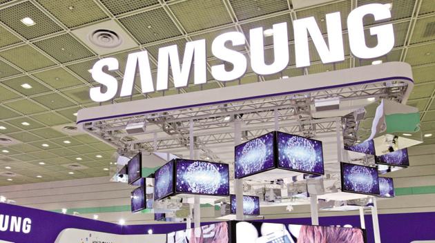 Visitors walk past the Samsung Electronics Co. booth.