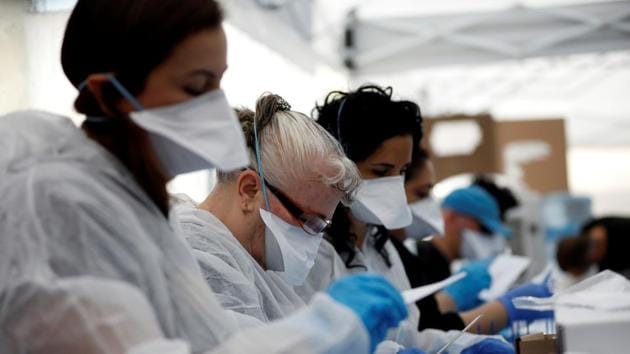 Israeli election monitors wearing protective gear count votes cast by Israelis in home-quarantine over coronavirus concerns following Israel's national election, in Shoham, Israel March 4, 2020.