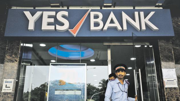 A watchman steps out of a Yes Bank branch in Mumbai, India.