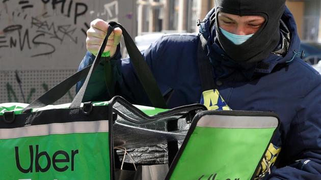 An Uber Eats food delivery courier closes a bag with an order during a lockdown, imposed to prevent the spread of coronavirus disease (COVID-19), in central Kiev, Ukraine April 2, 2020.