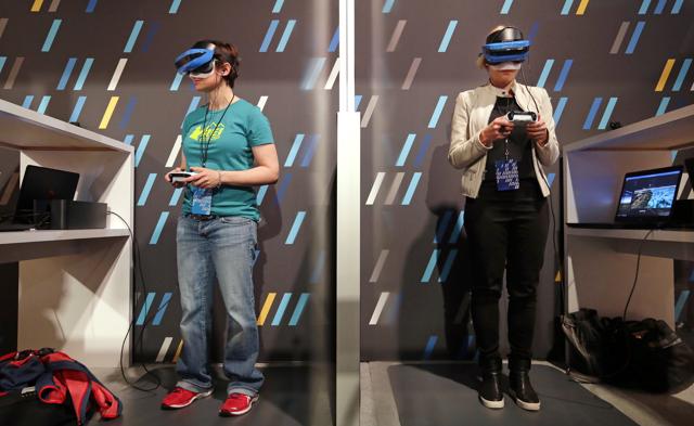 Two women wearing HoloLens devices try out a Windows mixed reality immersive experience at the Microsoft Build 2017 developers conference on Wednesday in Seattle. Earlier in the day at the annual event, Microsoft CEO Satya Nadella said that a half billion devices are now running Windows 10, its latest operating system. That's up from 400 million disclosed last September, but far short of a goal of 1 billion by 2018. Two women wearing HoloLens devices try out a Windows mixed reality immersive experience at the Microsoft Build 2017 developers conference on Wednesday in Seattle. Earlier in the day at the annual event, Microsoft CEO Satya Nadella said that a half billion devices are now running Windows 10, its latest operating system. That's up from 400 million disclosed last September, but far short of a goal of 1 billion by 2018.