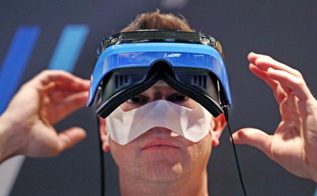 Microsoft employee Dave Rogers pulls off a HoloLens device after trying it out in a Windows mixed reality immersive experience at the Microsoft Build 2017 developers conference in Seattle. Microsoft employee Dave Rogers pulls off a HoloLens device after trying it out in a Windows mixed reality immersive experience at the Microsoft Build 2017 developers conference in Seattle.