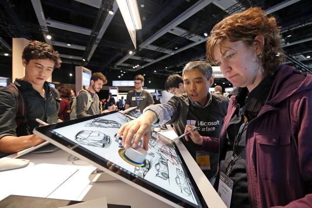 Microsoft employee Anne Walker, right, is shown a Surface Studio device by Fei Su at the Microsoft Build 2017 developers conference in Seattle. Microsoft employee Anne Walker, right, is shown a Surface Studio device by Fei Su at the Microsoft Build 2017 developers conference in Seattle.