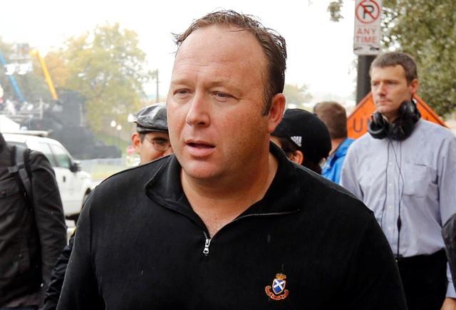 FILE PHOTO: Conspiracy theorist, radio talk show host and Infowars.net founder Alex Jones walks up Elm Street past the spot where U.S. President John F. Kennedy was assassinated in Dealey Plaza in 1963 one day before commemorations of the 50th anniversary of the assassination in Dallas, Texas, U.S., November 21, 2013. FILE PHOTO: Conspiracy theorist, radio talk show host and Infowars.net founder Alex Jones walks up Elm Street past the spot where U.S. President John F. Kennedy was assassinated in Dealey Plaza in 1963 one day before commemorations of the 50th anniversary of the assassination in Dallas, Texas, U.S., November 21, 2013.