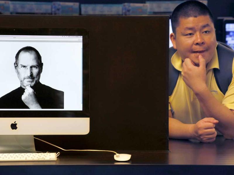 An iMac computer shows the image of Apple co-founder Steve Jobs as a mainland tourist sits near by at an electronic shop in Hong Kong. An iMac computer shows the image of Apple co-founder Steve Jobs as a mainland tourist sits near by at an electronic shop in Hong Kong.
