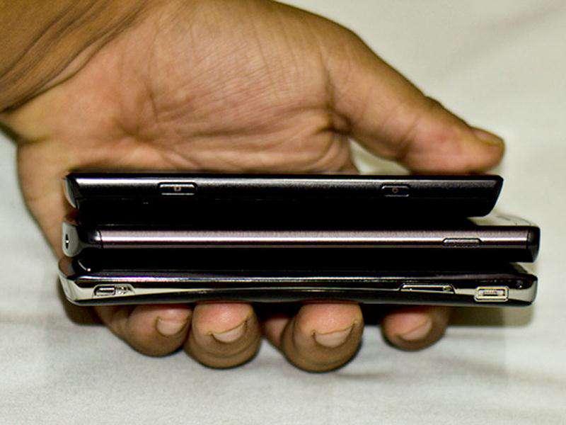 Comparing the sizes. From top to bottom - Samsung Omnia W, Samsung Wave III, and Sony Xperia Arc S. Comparing the sizes. From top to bottom - Samsung Omnia W, Samsung Wave III, and Sony Xperia Arc S.