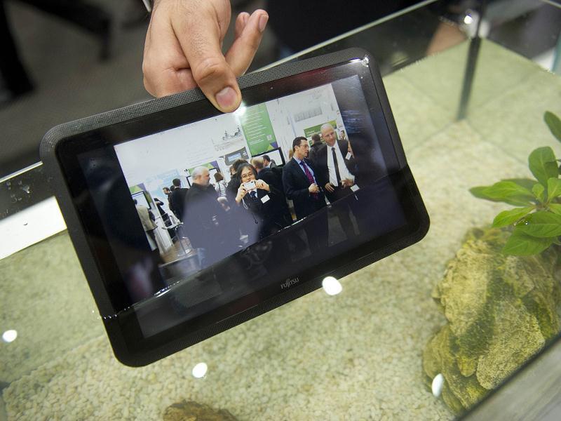 A waterproof tablet PC from Fujitsu is seen lowered into a fish tank at the world's biggest high-tech fair, the CeBIT, on March 6, 2012 in Hanover, central Germany. Brazil is the partner country of the CeBIT 2012, which is running until March 10, 2012. AFP PHOTO / ODD ANDERSEN A waterproof tablet PC from Fujitsu is seen lowered into a fish tank at the world's biggest high-tech fair, the CeBIT, on March 6, 2012 in Hanover, central Germany. Brazil is the partner country of the CeBIT 2012, which is running until March 10, 2012. AFP PHOTO / ODD ANDERSEN