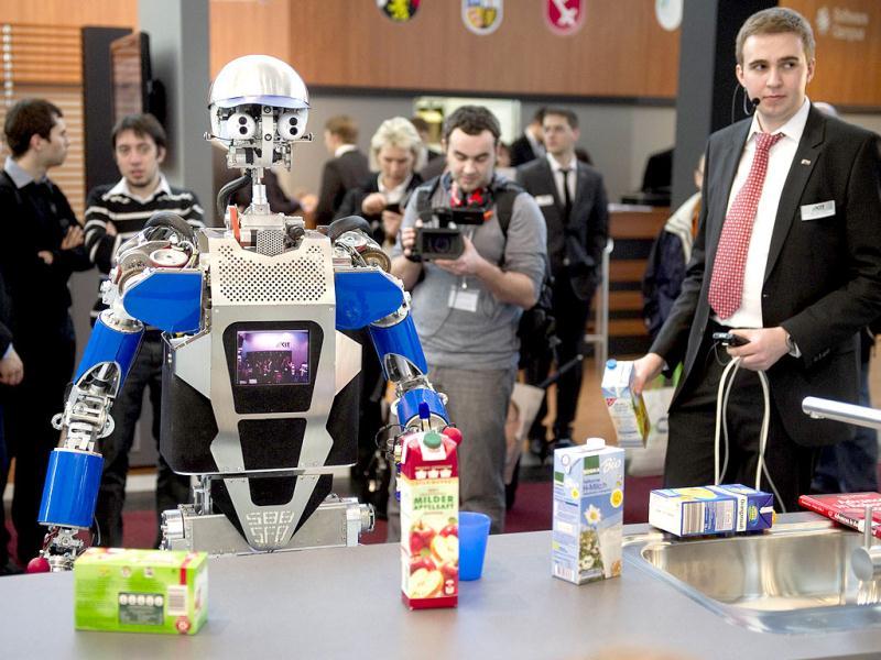A robot said to be able to cook is taking stock of groceries in hall 26 at the world's biggest high-tech fair, the CeBIT, on March 6, 2012 in Hanover, central Germany. Brazil is the partner country of the CeBIT 2012, which is running until March 10. AFP PHOTO / ODD ANDERSEN A robot said to be able to cook is taking stock of groceries in hall 26 at the world's biggest high-tech fair, the CeBIT, on March 6, 2012 in Hanover, central Germany. Brazil is the partner country of the CeBIT 2012, which is running until March 10. AFP PHOTO / ODD ANDERSEN