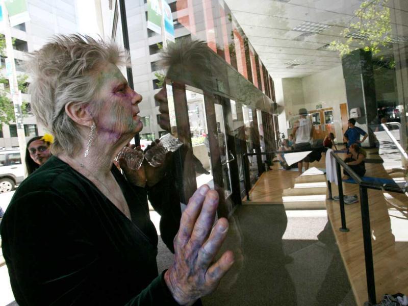 A zombie look inside of a fitness gym through a window to surprise people. AFP PHOTO / Kimihiro Hoshino A zombie look inside of a fitness gym through a window to surprise people. AFP PHOTO / Kimihiro Hoshino