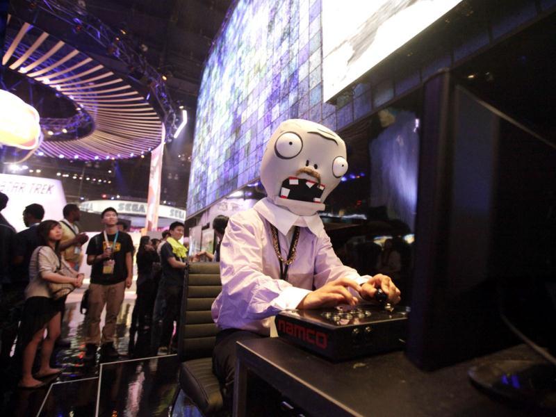 A man dressed as a zombie from Plants vs Zombies mobile app game plays a video game at the Namco Bandai booth at E3 2012 in Los Angeles. AP Photo/Jae C. Hong A man dressed as a zombie from Plants vs Zombies mobile app game plays a video game at the Namco Bandai booth at E3 2012 in Los Angeles. AP Photo/Jae C. Hong