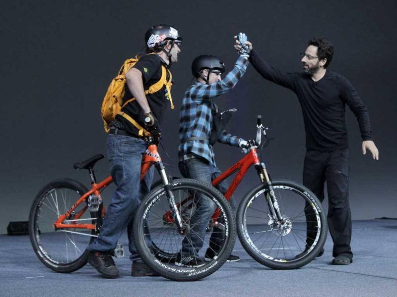 Google co-founder Sergey Brin, right, congratulates two parachutists during a demonstration of Google's new Project Glass, its futuristic, Internet-connected glasses. (AP Photo/Paul Sakuma) Google co-founder Sergey Brin, right, congratulates two parachutists during a demonstration of Google's new Project Glass, its futuristic, Internet-connected glasses. (AP Photo/Paul Sakuma)