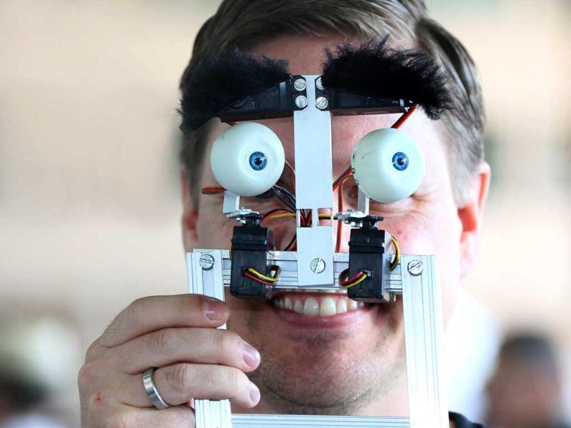 A selfmade technical face is shown by a man at at the Campus Party Europe electronic entertainment event in Berlin. The weeklong, 24-hours-a-day technology festival for thousands of “campuseros” - hackers, developers, gamers and geeks is running until August 26, 2012. Equipped with computers and other toys, participants camp on-site and immerse themselves in their technical environment. AFP PHOTO / STEPHANIE PILICK A selfmade technical face is shown by a man at at the Campus Party Europe electronic entertainment event in Berlin. The weeklong, 24-hours-a-day technology festival for thousands of “campuseros” - hackers, developers, gamers and geeks is running until August 26, 2012. Equipped with computers and other toys, participants camp on-site and immerse themselves in their technical environment. AFP PHOTO / STEPHANIE PILICK