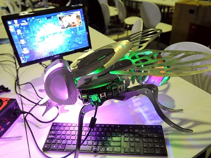 A computer and a robot are seen at the Campus Party Europe electronic entertainment event in Berlin. The weeklong, 24-hours-a-day technology festival for thousands of “campuseros” - hackers, developers, gamers and geeks is running until August 26, 2012. Equipped with computers and other toys, participants camp on-site and immerse themselves in their technical environment. AFP PHOTO / BRITTA PEDERSEN A computer and a robot are seen at the Campus Party Europe electronic entertainment event in Berlin. The weeklong, 24-hours-a-day technology festival for thousands of “campuseros” - hackers, developers, gamers and geeks is running until August 26, 2012. Equipped with computers and other toys, participants camp on-site and immerse themselves in their technical environment. AFP PHOTO / BRITTA PEDERSEN
