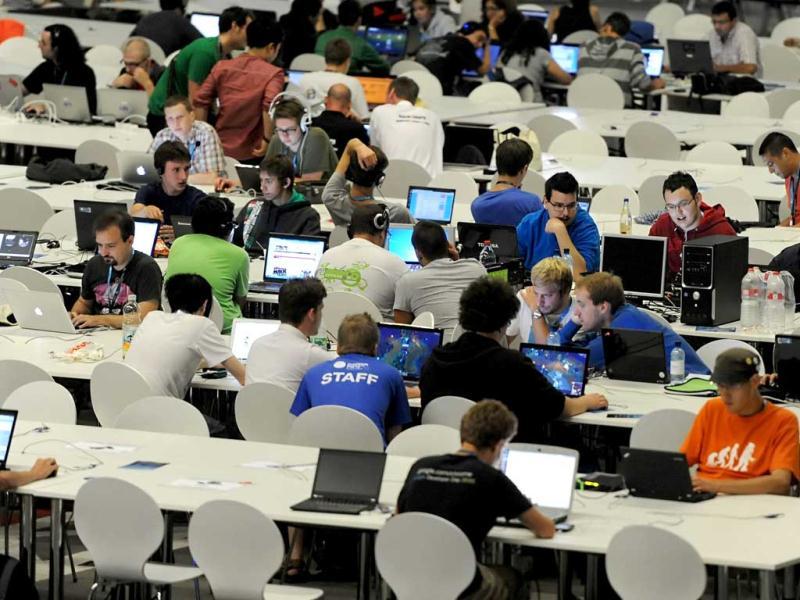 Young people work on their computers as they take part in the Campus Party Europe electronic entertainment event in Berlin. The weeklong, 24-hours-a-day technology festival for thousands of “campuseros” - hackers, developers, gamers and geeks is running until August 26, 2012. Equipped with computers and other toys, participants camp on-site and immerse themselves in their technical environment. AFP PHOTO / BRITTA PEDERSEN Young people work on their computers as they take part in the Campus Party Europe electronic entertainment event in Berlin. The weeklong, 24-hours-a-day technology festival for thousands of “campuseros” - hackers, developers, gamers and geeks is running until August 26, 2012. Equipped with computers and other toys, participants camp on-site and immerse themselves in their technical environment. AFP PHOTO / BRITTA PEDERSEN