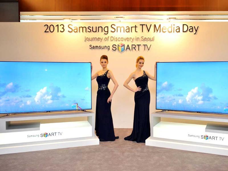 Models pose with Samsung Electronics' new 75 inch F8000 Smart LED TV during a media conference in Seoul on February 19, 2013. South Korea's Samsung Electronics on February 19 launched a set of giant, Internet-enabled televisions aimed at boosting profit margins and cementing its lead on the world's TV markets hit by slowing global demand. Photo: AFP / Jung Yeon-Je Models pose with Samsung Electronics' new 75 inch F8000 Smart LED TV during a media conference in Seoul on February 19, 2013. South Korea's Samsung Electronics on February 19 launched a set of giant, Internet-enabled televisions aimed at boosting profit margins and cementing its lead on the world's TV markets hit by slowing global demand. Photo: AFP / Jung Yeon-Je