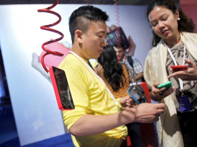 Visitors look at Nokia's new $99 phone in its mid-range Asha line after it was unveiled at a launch in New Delhi. (Reuters) Visitors look at Nokia's new $99 phone in its mid-range Asha line after it was unveiled at a launch in New Delhi. (Reuters)