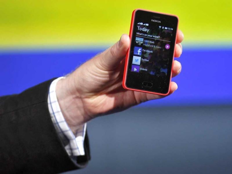 A Nokia official displays a new $99 phone in its mid-range Asha line at a launch in New Delhi. (Reuters) A Nokia official displays a new $99 phone in its mid-range Asha line at a launch in New Delhi. (Reuters)