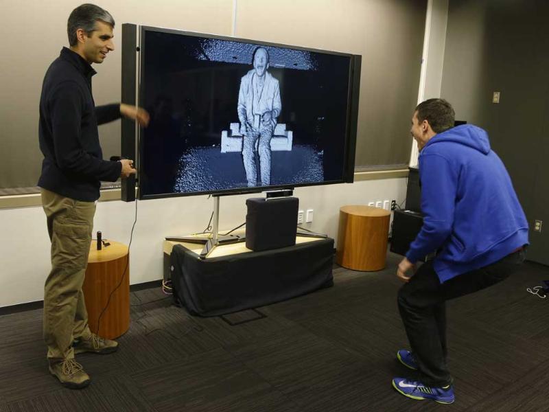 Kareem Choudhry, left, development manager for Microsoft Corp.'s Kinect motion-sensing device for the Xbox, demonstrates the level of detail in the camera of the new Kinect for the next-generation Xbox One entertainment and gaming console system to a visiting journalist, right, during a demonstration in Redmond, Wash. Photo: AP/Ted S. Warren Kareem Choudhry, left, development manager for Microsoft Corp.'s Kinect motion-sensing device for the Xbox, demonstrates the level of detail in the camera of the new Kinect for the next-generation Xbox One entertainment and gaming console system to a visiting journalist, right, during a demonstration in Redmond, Wash. Photo: AP/Ted S. Warren