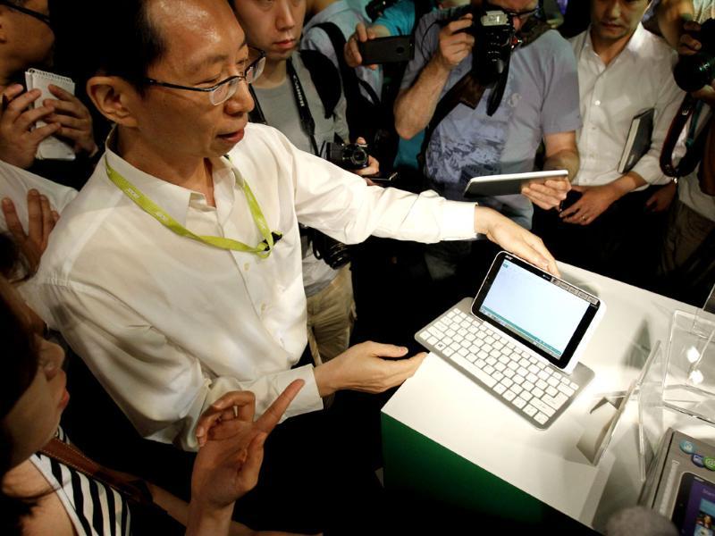An Acer employee displays a new tablet Iconia W3 at an international press conference on the eve of the opening of Computex , one of the world's largest IT exhibitions, in Taipei. Photo: AP/Wally Santana An Acer employee displays a new tablet Iconia W3 at an international press conference on the eve of the opening of Computex , one of the world's largest IT exhibitions, in Taipei. Photo: AP/Wally Santana