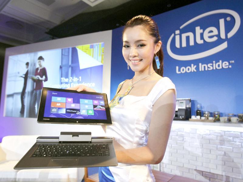 A model at Intel Corp.'s press conference displays a new Toshiba tablet hybrid at the opening of Taiwan's Computex 2013, one of the world's largest IT exhibitions, in Taipei. Photo: AP/Wally Santana A model at Intel Corp.'s press conference displays a new Toshiba tablet hybrid at the opening of Taiwan's Computex 2013, one of the world's largest IT exhibitions, in Taipei. Photo: AP/Wally Santana