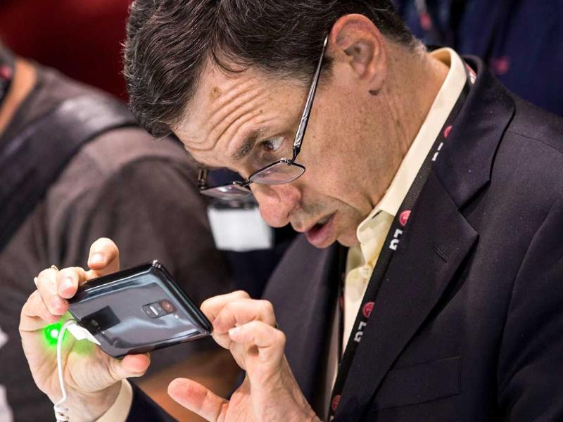 A man looks at the LG G2 smartphone at the phone's launch event in New York City. Photo: Andrew Burton Getty Images AFP A man looks at the LG G2 smartphone at the phone's launch event in New York City. Photo: Andrew Burton Getty Images AFP