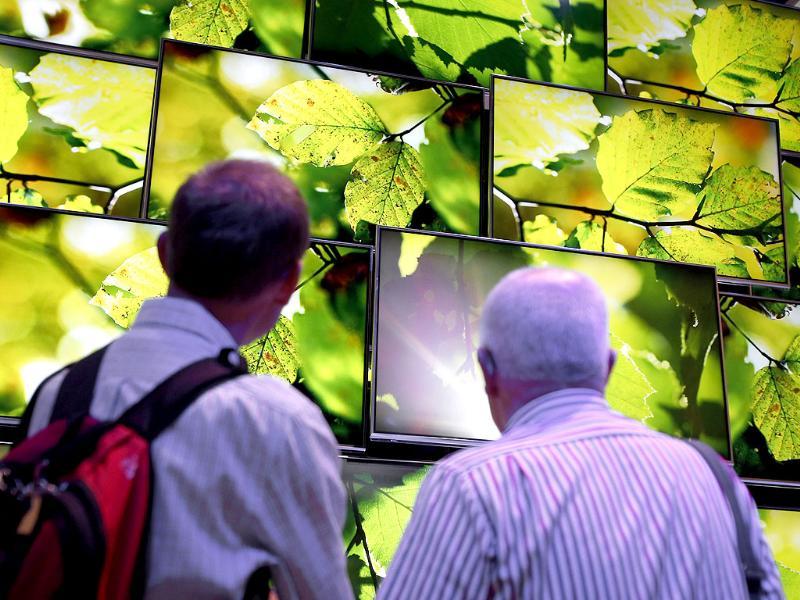 Visitors look at Panasonic Ultra HD TV screens at the IFA, one of the world's largest trade fairs for consumer electronics and electrical home appliances in Berlin, Germany Photo: AP/Michael Sohn Visitors look at Panasonic Ultra HD TV screens at the IFA, one of the world's largest trade fairs for consumer electronics and electrical home appliances in Berlin, Germany Photo: AP/Michael Sohn