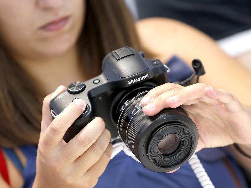 A visitor tests a Samsung camera at the IFA, one of the world's largest trade fairs for consumer electronics and electrical home appliances in Berlin, Germany. Photo: AP/Michael Sohn A visitor tests a Samsung camera at the IFA, one of the world's largest trade fairs for consumer electronics and electrical home appliances in Berlin, Germany. Photo: AP/Michael Sohn