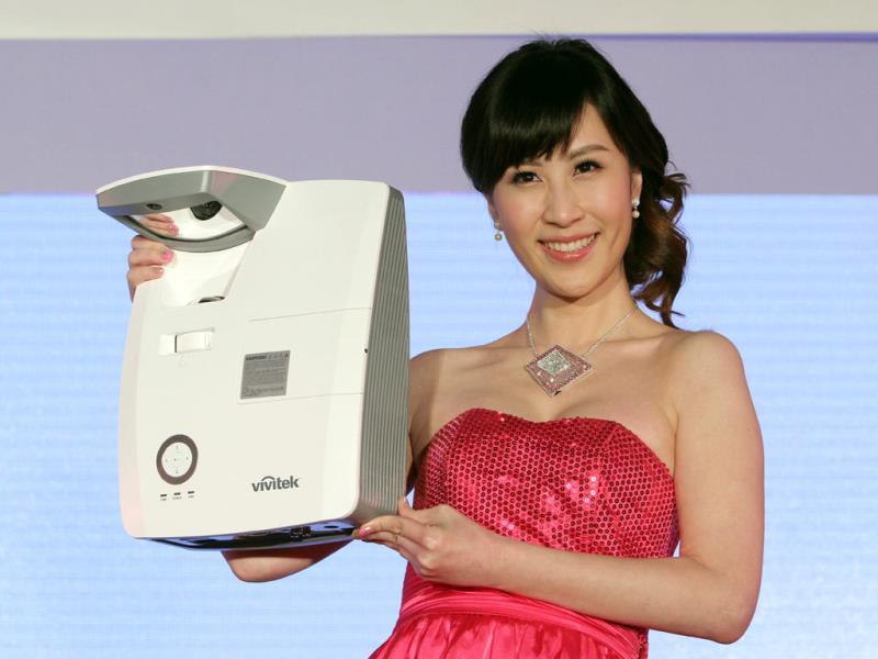 A model displays Delta's D755WTIR Ultra-short throw interactive projector during a press event on the eve of the Computex Taipei. Photo: AP/Chiang Ying-ying A model displays Delta's D755WTIR Ultra-short throw interactive projector during a press event on the eve of the Computex Taipei. Photo: AP/Chiang Ying-ying