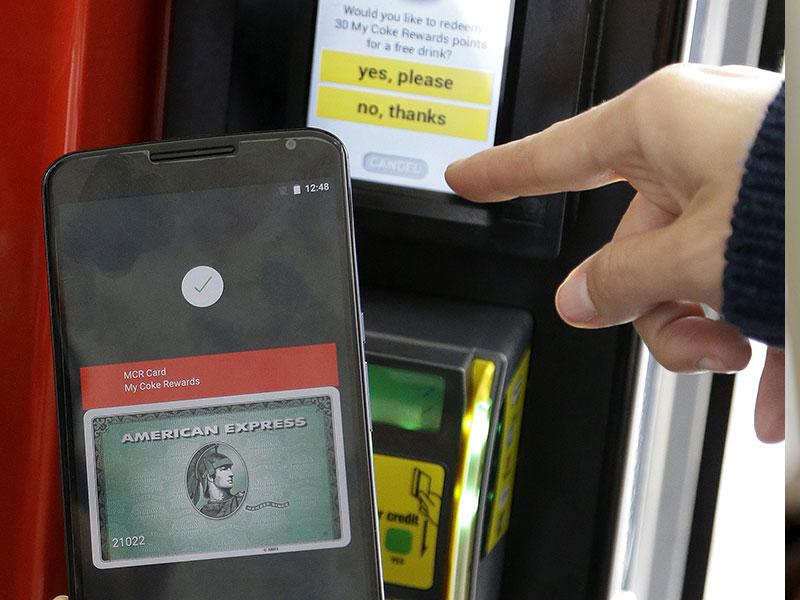 A Google employee gives a demonstration of Android Pay on a phone at Google I/O 2015 in San Francisco. Photo: AP A Google employee gives a demonstration of Android Pay on a phone at Google I/O 2015 in San Francisco. Photo: AP