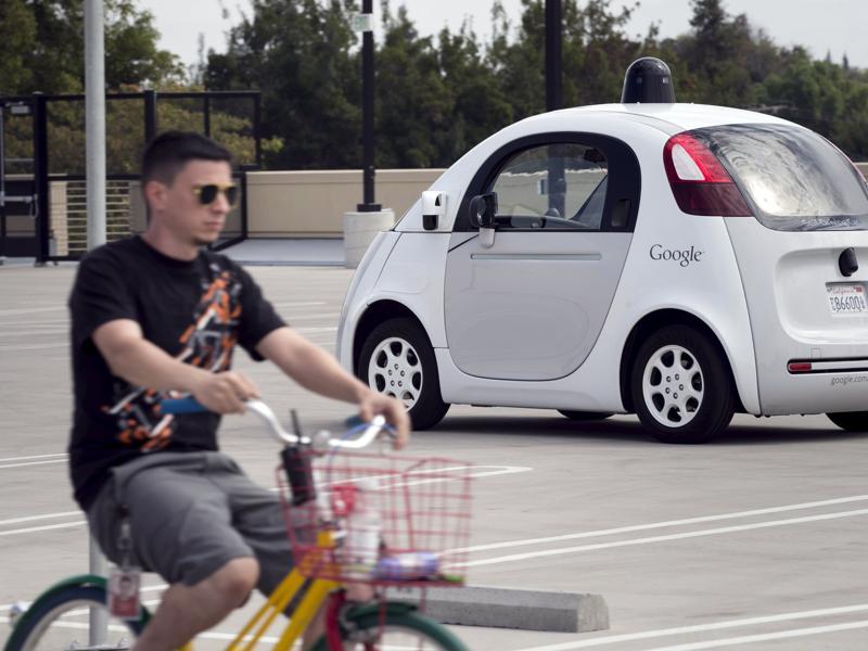 A Google employee on a bicycle acts as a real-life obstacle for a Google self-driving prototype car to react to (REUTERS) A Google employee on a bicycle acts as a real-life obstacle for a Google self-driving prototype car to react to (REUTERS)