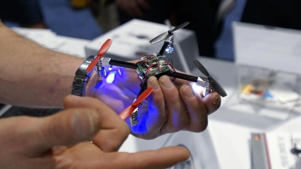 A vendor demonstrates the Micro Drone for a prospective retailer at the International Consumer Electronics show (CES) in Las Vegas, Nevada.