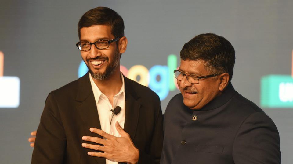 CEO of Google Inc. Sundar Pichai (L) shakes hands with union minister for information technology Ravi Shankar Prasad at the end of a meeting about partnering with small business in New Delhi on January 4, 2017.