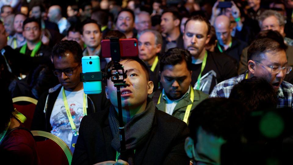 A showgoer uses two smartphones before the Nvidia keynote address at CES in Las Vegas, January 4, 2017. A showgoer uses two smartphones before the Nvidia keynote address at CES in Las Vegas, January 4, 2017.