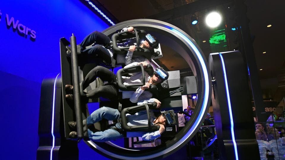 Attendees participate in a Samsung virtual reality ride at CES 2017 at the Las Vegas Convention Center in Las Vegas, Nevada.