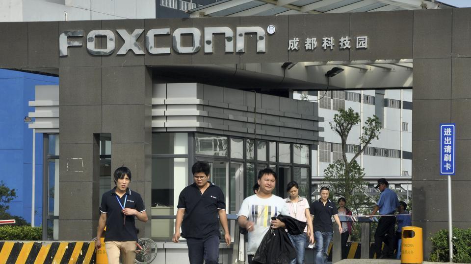 Workers walk out of the entrance to a Foxconn factory in Chengdu, Sichuan province. Apple and its suppliers such as Taiwanese tycoon Terry Gou's Foxconn Technology Group have been the target of labour rights groups, which say the world's most valuable technology company are making iPhones and iPads in massive sweat shops.
