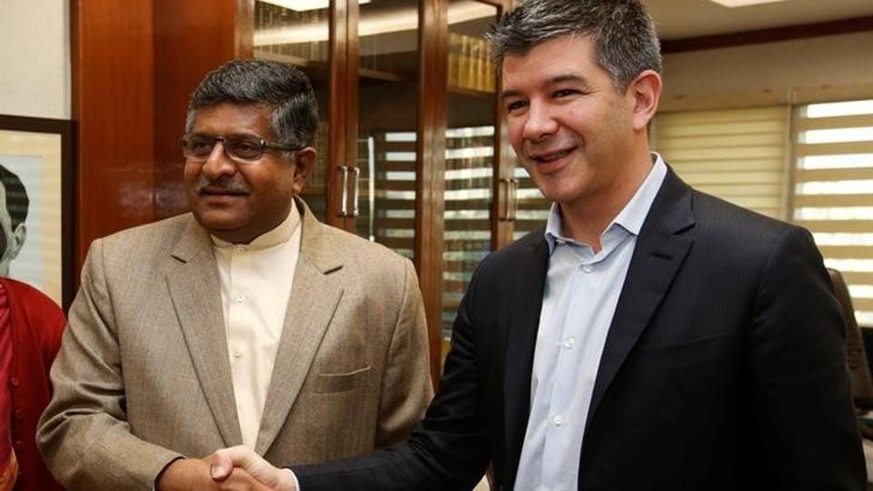 A file photo shows minister of law and information and technology Ravi Shankar Prasad (L) shaking hands with Uber CEO Travis Kalanick before the start of their meeting in New Delhi, India.