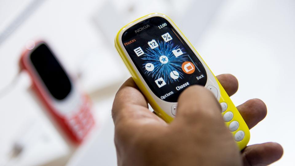 A person tests the new Nokia 3310 model of Finnish HMD global at the Mobile World Congress on the first day of the MWC in Barcelona.