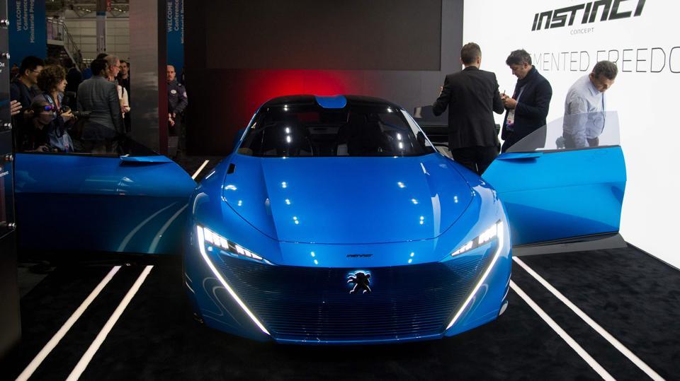 Visitors look at the Peugeot car ‘Instinct’, connected by Samsung technology (AFP) Visitors look at the Peugeot car ‘Instinct’, connected by Samsung technology (AFP)