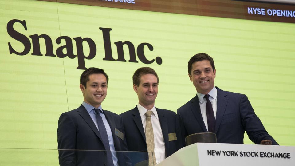 Snapchat co-founders Bobby Murphy(L) and Evan Spiegel(C) prepare to ring the opening bell as Thomas Farley, president of the NYSE, looks on. Snapchat co-founders Bobby Murphy(L) and Evan Spiegel(C) prepare to ring the opening bell as Thomas Farley, president of the NYSE, looks on.