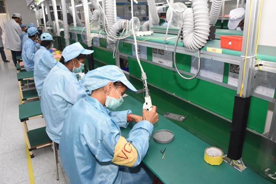 Staff working at the manufacturing line in a domestic smartphone production facility.