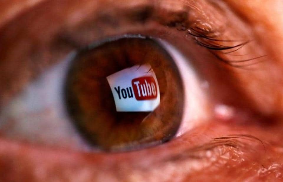A picture illustration shows a YouTube logo reflected in a person's eye.
