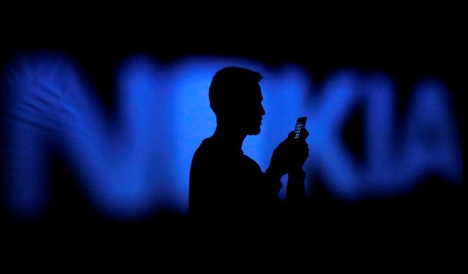 A photo illustration of a man silhouetted against a Nokia logo in the central Bosnian town of Zenica.