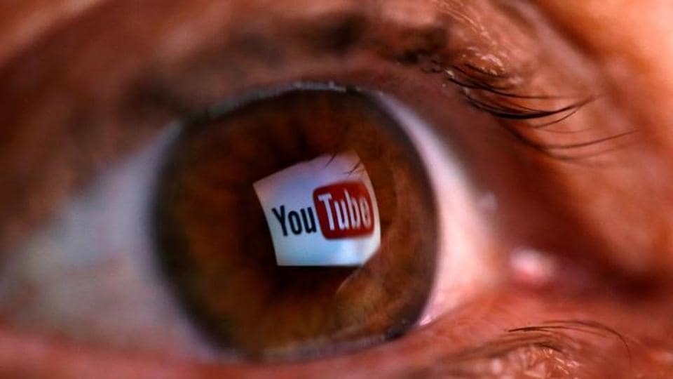 A picture illustration shows a YouTube logo reflected in a person's eye.