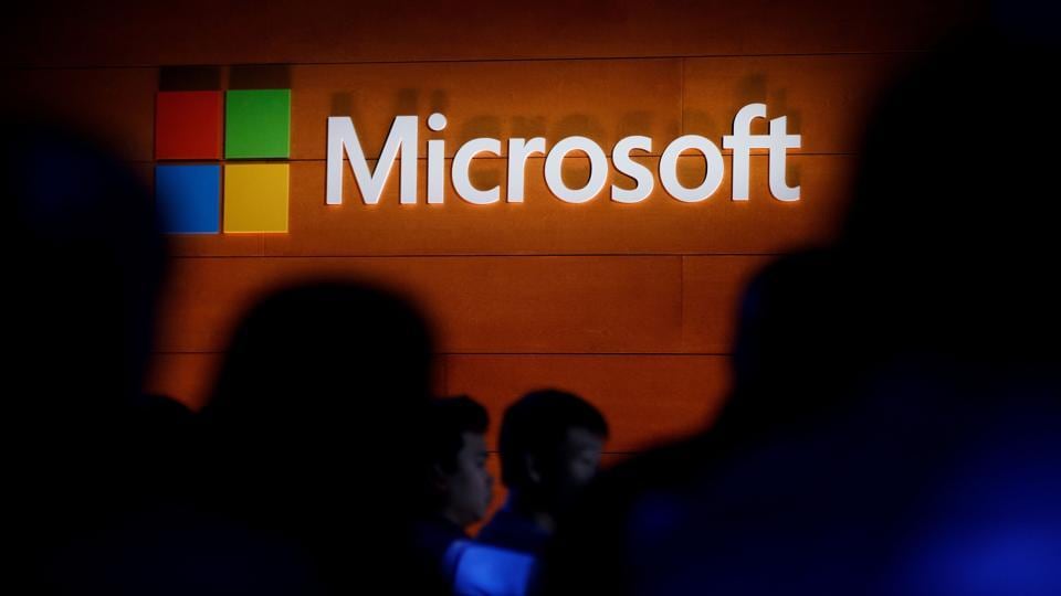 The Microsoft logo is illuminated on a wall during an event in New York City.