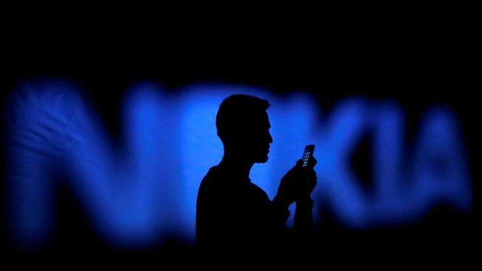 A man silhouetted against a Nokia logo in the central Bosnian town of Zenica.