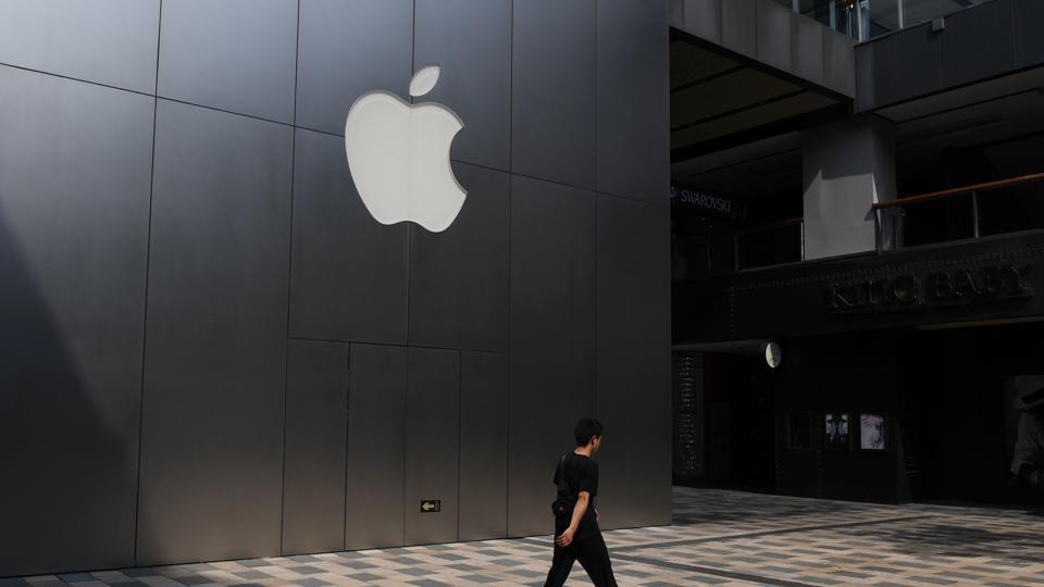This photo taken on August 3, 2017 shows a man walking past an Apple store in Beijing. Enterprising internet users in China fear the tools they use to tunnel through the country's 