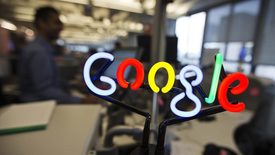A neon Google logo is seen as employees work at the new Google office in Toronto, November 13, 2012.